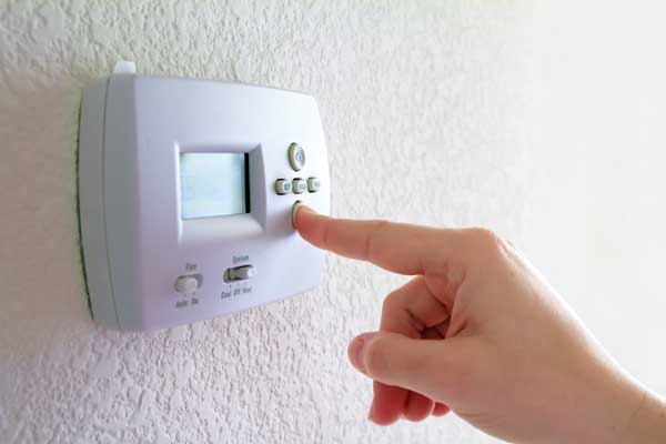 Hand setting a central heating thermostat